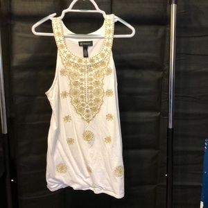 Sundress with gold embellishments. Round neckline